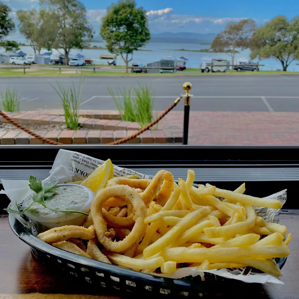Golden calamari rings and chips with scenic lake views