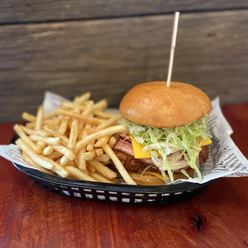 Chicken burger with bacon served with golden fries