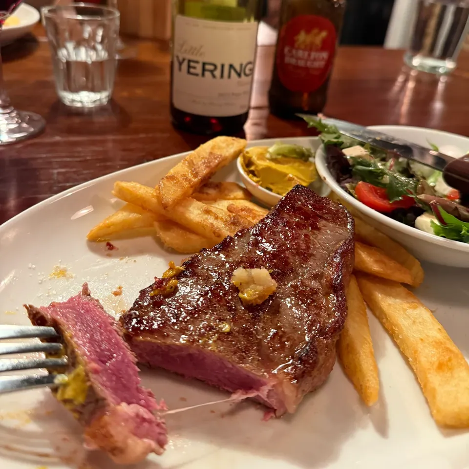 Porterhouse steak served with a glass of red wine